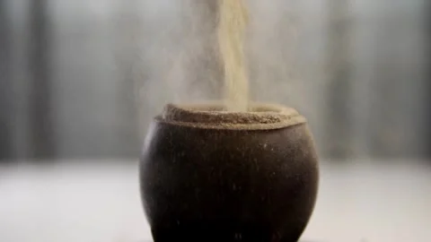 Loose mate herb falling into traditional leather wrapped gourd for preparat.. Stock Footage 337689633
