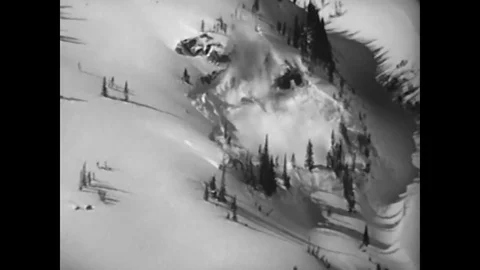 A loose snow avalanche combines with a wind slab avalanche in a natural disaster Stock Footage 79420416