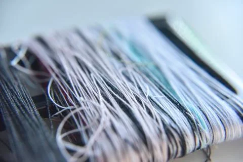 Loose threads spooled around a black frame Stock Photos