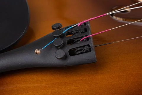 Loose violin string on the side of the tuning screws. Stock Photos