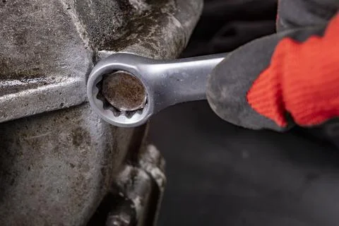Loosening the engine bolt with a spanner. Minor repair work on the internal c Foto stock
