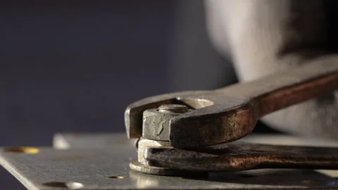 Loosening nut using wrench. Using spanner and vise to remove nut from bolt Stock Footage 304786251
