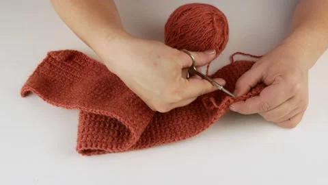 Loosens the yarn and winds the threads into a ball. Stock Footage 141211638