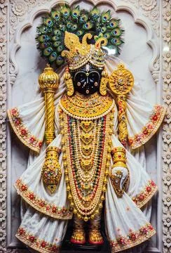Lord Krishna Dwarkadhish Idol Dressed in Ornate White Attire with Elaborate.. Stock Photos