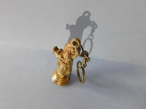 Lord Krishna micro statue and its shadow in a white floor Stock Photos