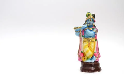 Lord Krishna Small Statue on White Paper Background. Stock Photos