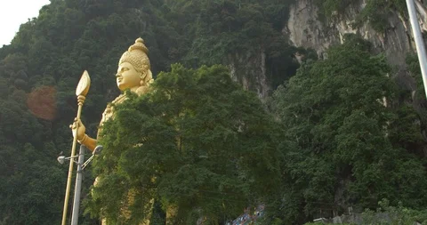 Lord marugan statue from right side facing sun Stock Footage 112848141