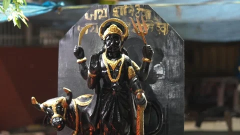 Lord Shani Dev Idol in Hindu Temple with Sacred Black Stone Background Stock Footage 339724835