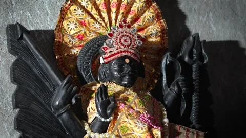 Lord Shani Dev Idol with Raised Blessing Hand and Ornate Crown in Hindu Templ Stock Footage 326360461