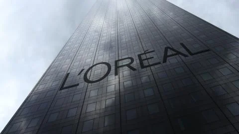 L'Oreal logo on a skyscraper facade reflecting clouds. Editorial 3D rendering' Ilustración de archivo