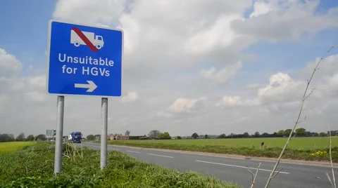 Lorries passing warning sign of unsuitable road for hgv's ahead uk Stock Footage 49846682