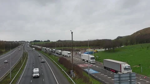 Lorries queue for port of Dover along the A20 in Kent Stock Footage 148546968
