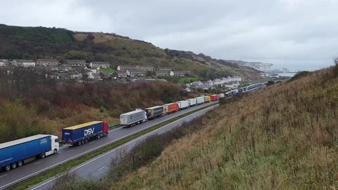 Lorries queue for the port of Dover along the A20 in Kent Stock Footage 148550733