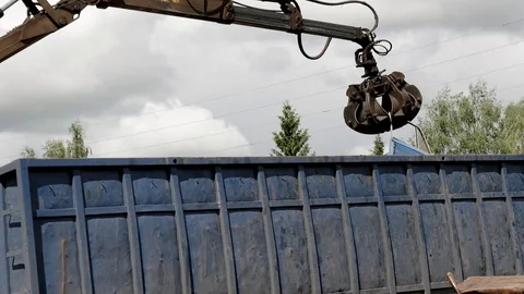 Lorry arm loader unloads scraps from heavy truck Stock Footage 91156138