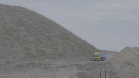 Lorry driving down the hill at a construction site Stock Footage 64552697