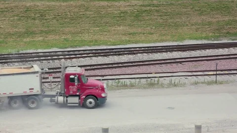 Lorry full of grain Passing beside train tracks  Stock Footage 79851041