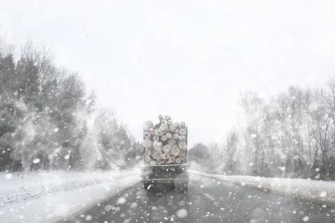 A lorry transports log in the back. Timber truck Stock Photos