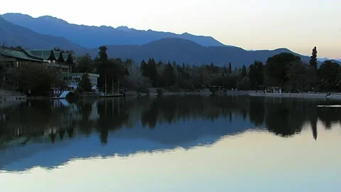 Los Andes blue Mountains reflected over a lake at the city park during sunset. Stock Footage 136867981