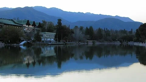 Los Andes blue Mountains reflected over a lake at the city park during sunset. Stock Footage 136868165