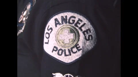 LOS ANGELES - 1975 - Close-up of an LAPD officer's badge and insignia patch. Stock Footage 338027885