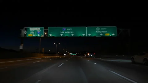 Los Angeles and Hollywood Freeway Signs Night Moving Shot Stock Footage