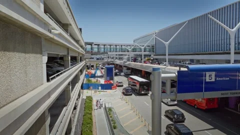 LOS ANGELES, CA - May 7, 2024: Car and shuttle bus traffic inside LAX airport Stock Footage 275119217