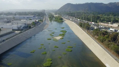 Los Angeles Morning Commute Aerial Boom Up Floating Over LA River with Freeway Stock Footage