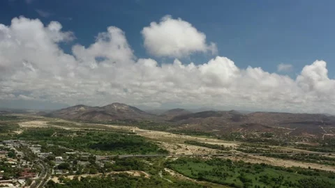 LOS CABOS MEXICO-2020: Clouds Mountains Sky View Farm Country Trees Skydiving Stock Footage 136246361