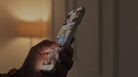 Lose-up of scrolling through Instagram Reels, a social media app on a Video stock 340415430