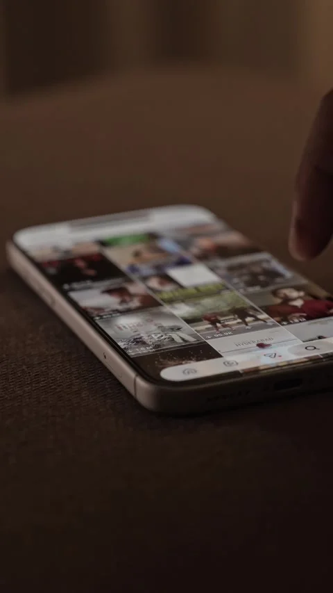 Lose-up of scrolling through Instagram Reels, a social media app on a Stock Footage 340415666