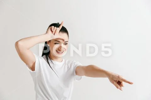 Losers go home. Portrait of woman showing loser sign over forehead Stock Photos