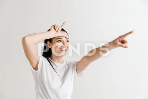 Losers go home. Portrait of woman showing loser sign over forehead Stock Photos