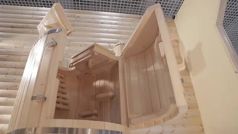 Loseup cedar phytobarrel. Inside, grates on floor,back and seat, and handstands Stock Footage 154243179