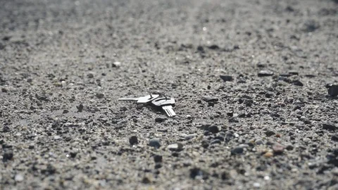 A lost bunch of keys falls to the ground, 2 variants + hand retrieving the keys Stock Footage 114061771