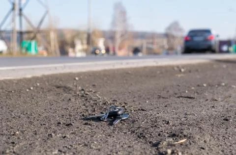 Lost bunch of keys lying on the side of the road Stock Photos