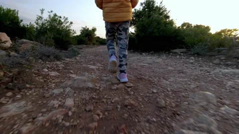 Lost child walking on a trail at sunset Video stock 169253015