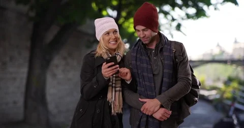 Lost couple in Paris use map on smartphone for directions Stock Footage 85329955