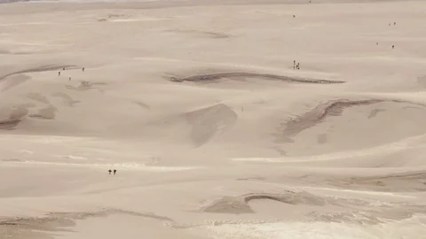 Lost in the desert: tiny figures at Great Sand Dunes, Colorado Stock Footage 77448157