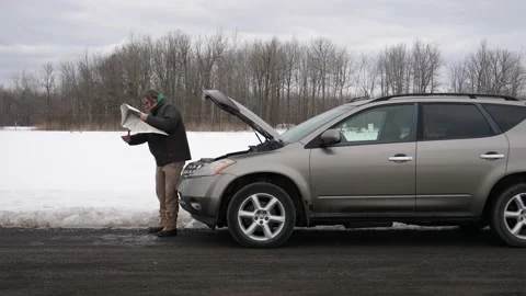 Lost Man With Broke Down Car Trying to Read a Map During Winter Stock Footage 150265497