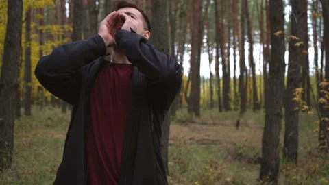 A lost man in the forest screams and asks for help Stock Footage 171521214