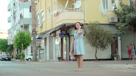 Lost Man in shorts and with a backpack behind his back with a smartphone in his Stock-Footage 165804868