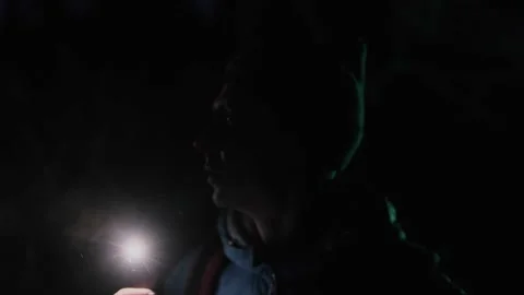 A lost man wandering through the dark forest at night, trying to find his way Stock Footage 302568773