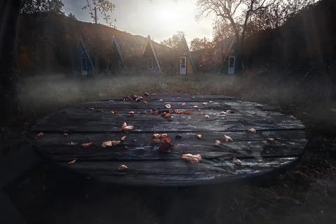 Lost place. Empty table. Abandoned resort. Rain and wind, flying leaves. Lonely Stock Photos