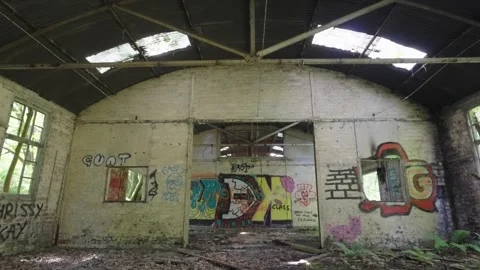 Lost place, offensive graffiti, abandoned room, door frame, broken windows Stock Footage 278092845