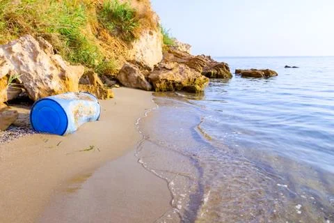 Lost plastic blue barrel on sandy beach Stock Photos