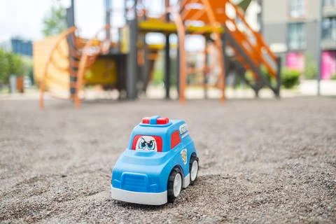 Lost plastic toy lying on playground floor in gloomy day, Lost toy Stock Photos