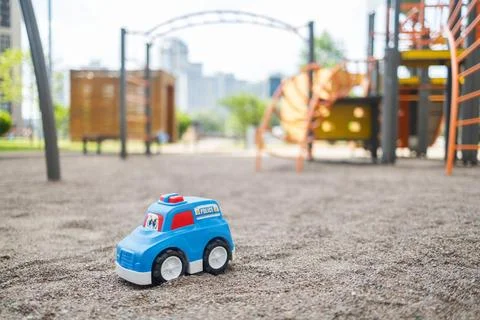 Lost plastic toy lying on playground floor in gloomy day, Lost toy Stock Photos