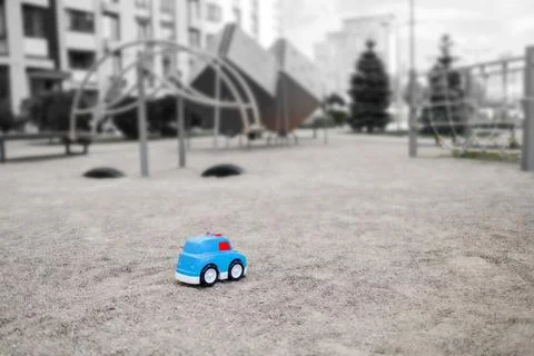 Lost plastic toy lying on playground floor in gloomy day, Lost toy Stock Photos