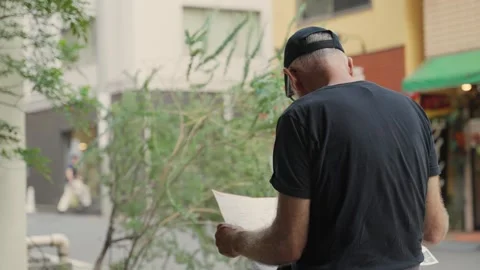 Lost tourist reading city map in Tokyo Stock Footage 340917581