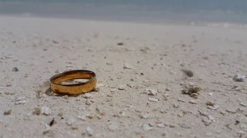 Lost wedding ring on the tropical white sand beach. Marriage problems and Stock Footage 118527551